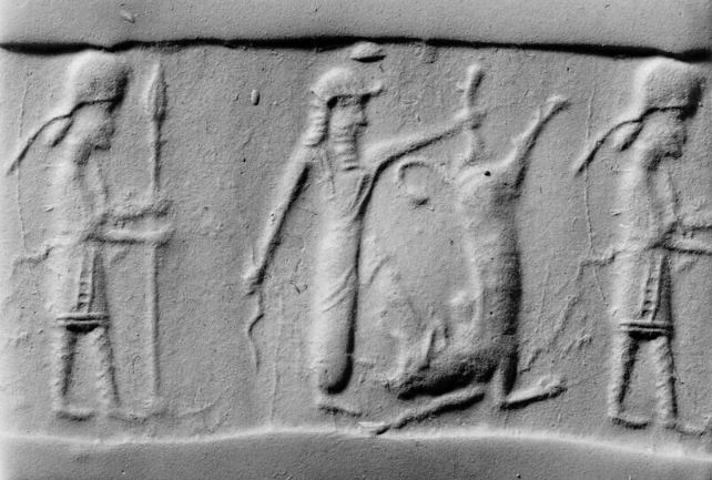 Hero fighting bull while armed attendant (spearman) stands behind