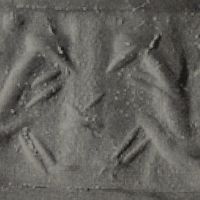 Two sitting monkeys flanking stylised plant