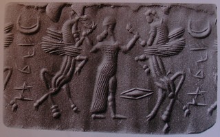 Hero grasping human-faced winged wild goat (ibex) on either side